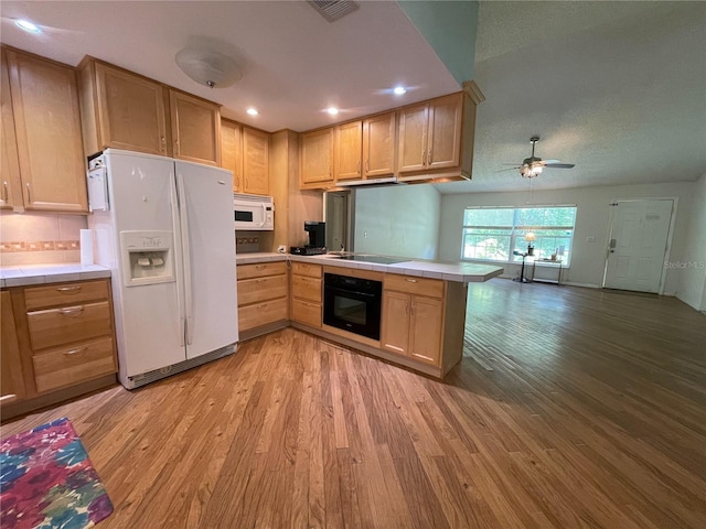 3647 Lake St, George Drive, Palm Harbor, FL 34684 - kitchen with black appliances, tile counters, a peninsula, light wood-type flooring, and a ceiling fan