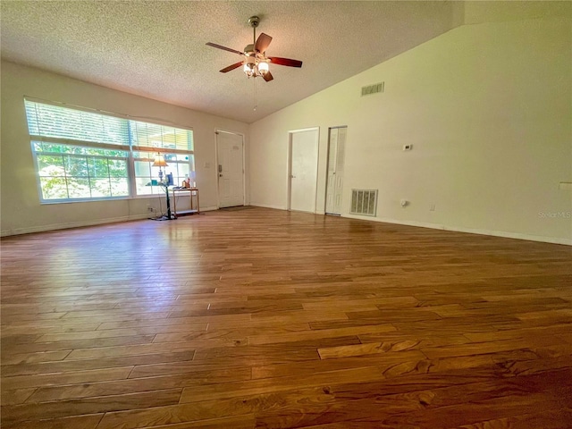 3647 Lake St, George Drive, Palm Harbor, FL 34684 - spare room featuring wood finished floors, vaulted ceiling, ceiling fan, and a textured ceiling