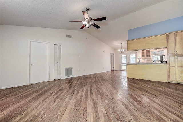3647 Lake St, George Drive, Palm Harbor, FL 34684 - unfurnished living room with a chandelier, a ceiling fan, wood finished floors, high vaulted ceiling, and a textured ceiling