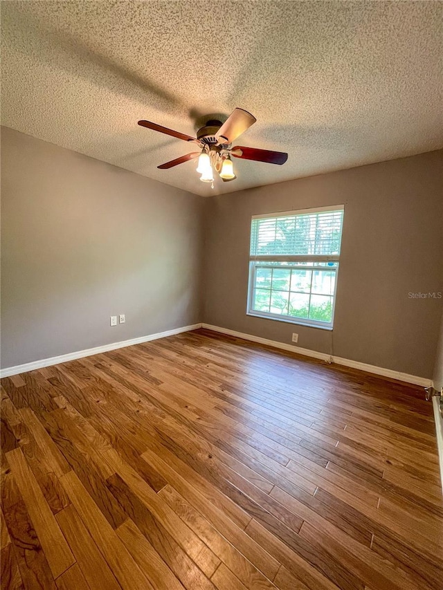 3647 Lake St, George Drive, Palm Harbor, FL 34684 - empty room featuring a ceiling fan, wood finished floors, and a textured ceiling