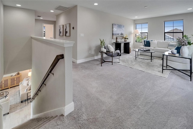 living area featuring visible vents, baseboards, recessed lighting, and carpet