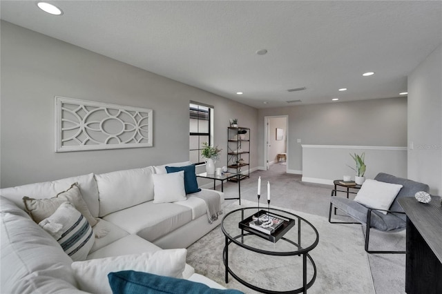 carpeted living room with recessed lighting, visible vents, and baseboards