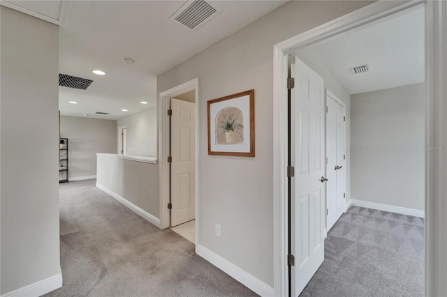 hall with visible vents and carpet