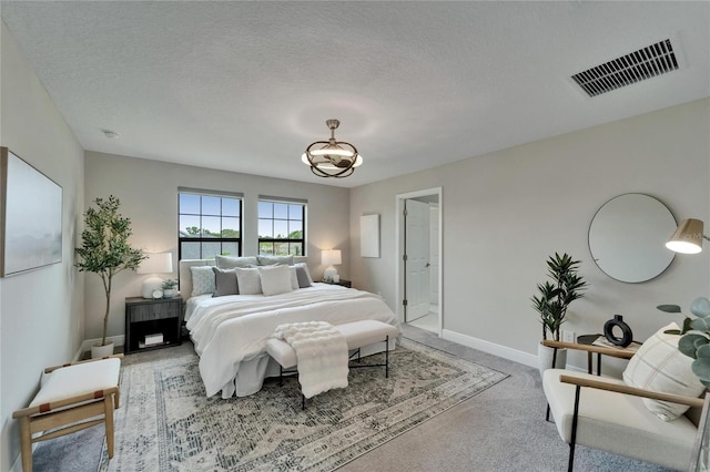 bedroom with visible vents, baseboards, a textured ceiling, and carpet floors