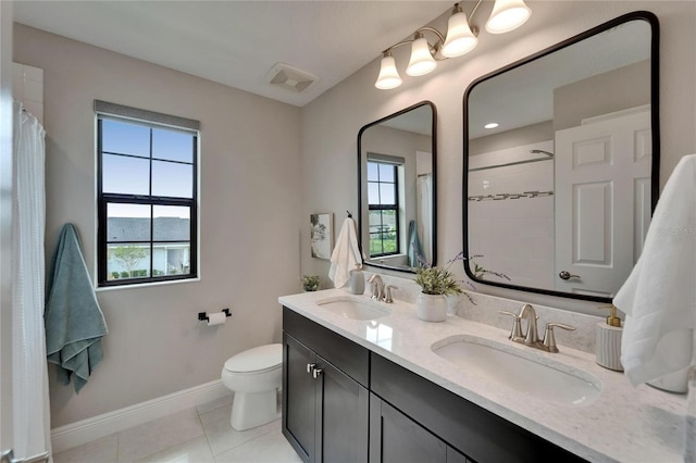 bathroom featuring a sink, visible vents, baseboards, and tile patterned flooring