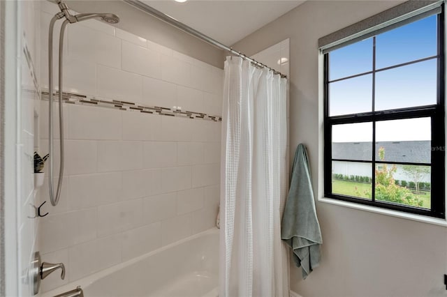 bathroom with shower / bathtub combination with curtain and a healthy amount of sunlight