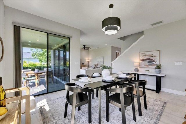 5601 Limelight Dr, Apollo Beach, FL 33572 - dining space with light wood-style floors and a ceiling fan