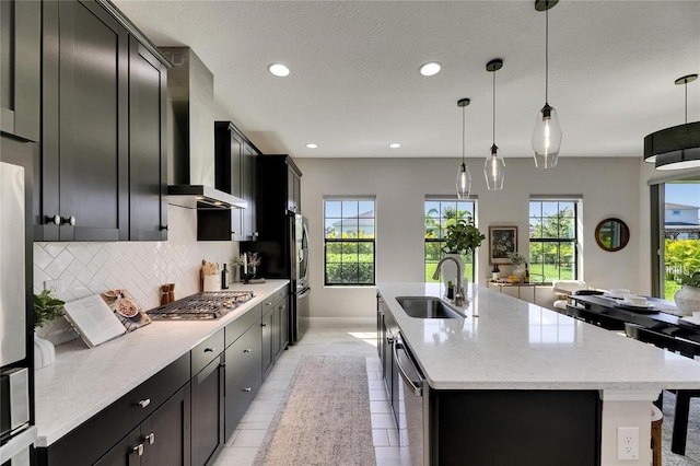 5601 Limelight Dr, Apollo Beach, FL 33572 - kitchen with appliances with stainless steel finishes, wall chimney range hood, dark cabinets, plenty of natural light, and recessed lighting