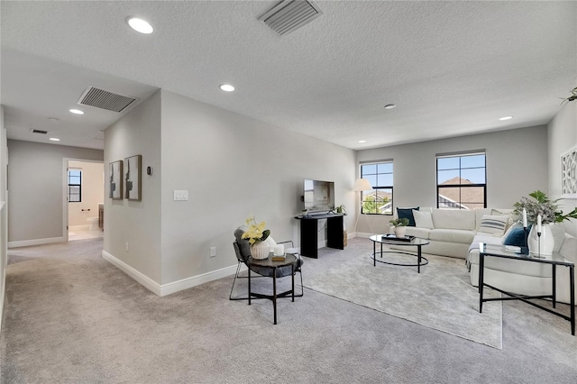 5601 Limelight Dr, Apollo Beach, FL 33572 - carpeted living room featuring recessed lighting and a textured ceiling