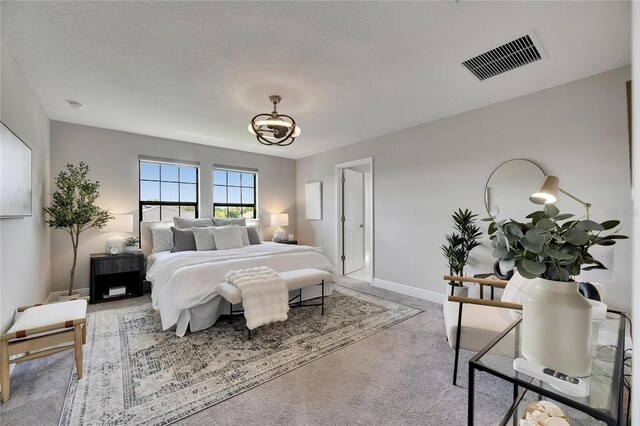 5601 Limelight Dr, Apollo Beach, FL 33572 - carpeted bedroom with baseboards and a chandelier