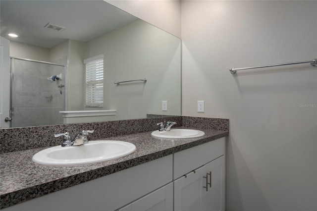 11704 Castine St, New Port Richey, FL 34654 - bathroom featuring a sink, double vanity, a stall shower, and visible vents