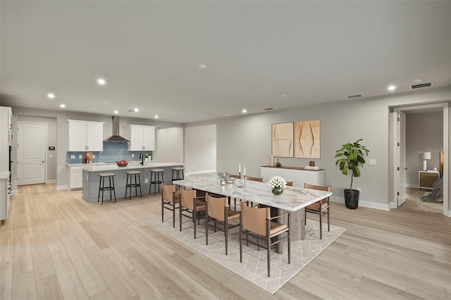 dining area with recessed lighting, baseboards, visible vents, and light wood-type flooring