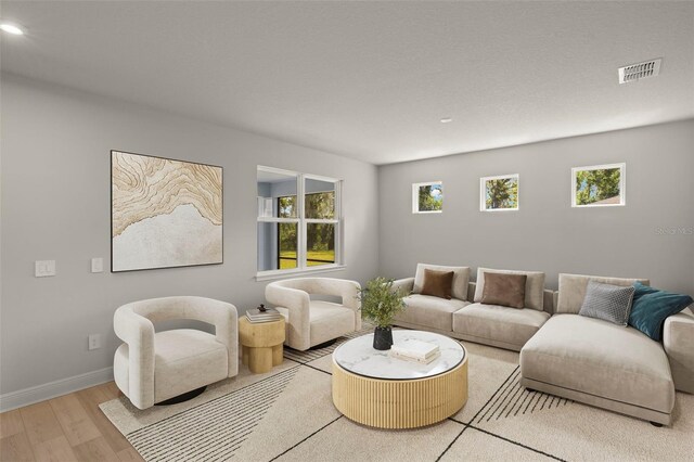 living room featuring visible vents, recessed lighting, baseboards, and wood finished floors