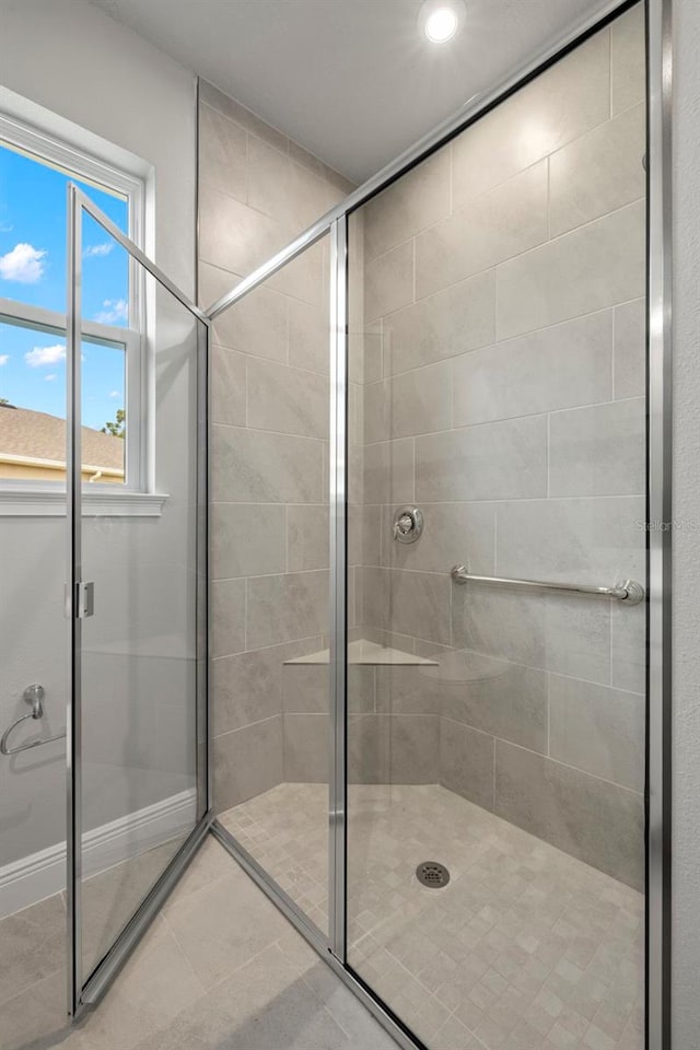 bathroom with recessed lighting, tile patterned flooring, and a stall shower