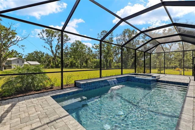 pool with glass enclosure, an in ground hot tub, a yard, and a patio area