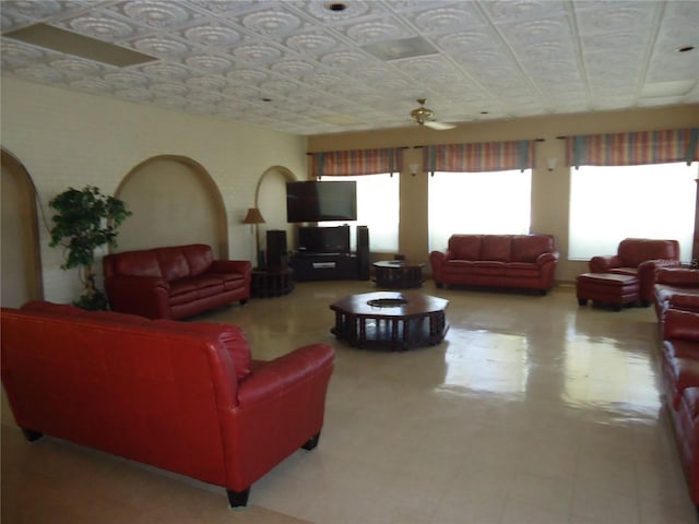 10034 64th Ave N Unit 21, Saint Petersburg, FL 33708 - living room with tile patterned floors, an ornate ceiling, and ceiling fan