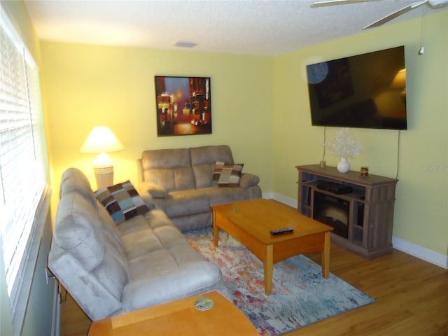 10034 64th Ave N Unit 21, Saint Petersburg, FL 33708 - living room featuring wood finished floors, baseboards, and a ceiling fan