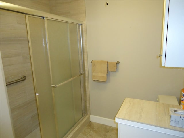 10034 64th Ave N Unit 21, Saint Petersburg, FL 33708 - bathroom with a stall shower, vanity, and baseboards