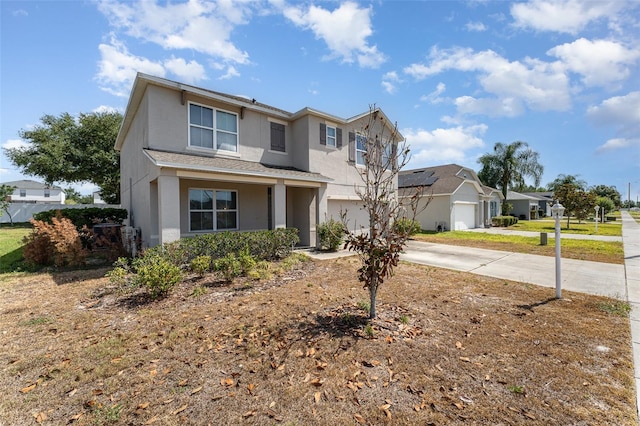 5597 Forest Ridge Dr, Winter Haven, FL 33881 - traditional home with driveway, stucco siding, and a garage