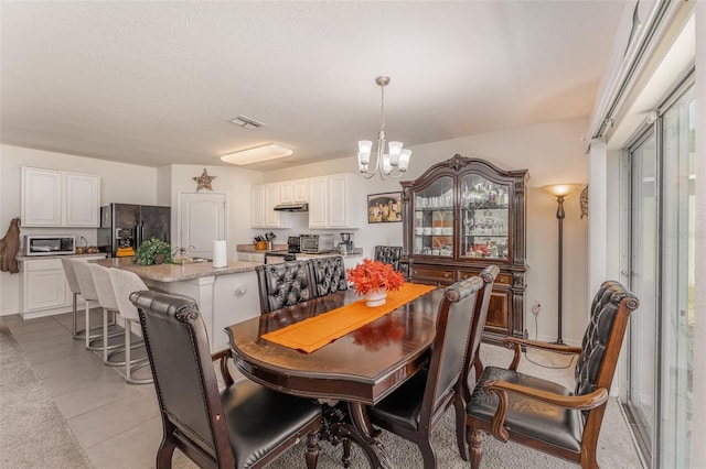 5597 Forest Ridge Dr, Winter Haven, FL 33881 - dining area with a chandelier and light tile patterned flooring