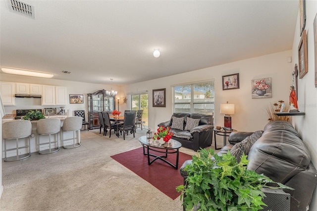 5597 Forest Ridge Dr, Winter Haven, FL 33881 - living area featuring a chandelier and light carpet