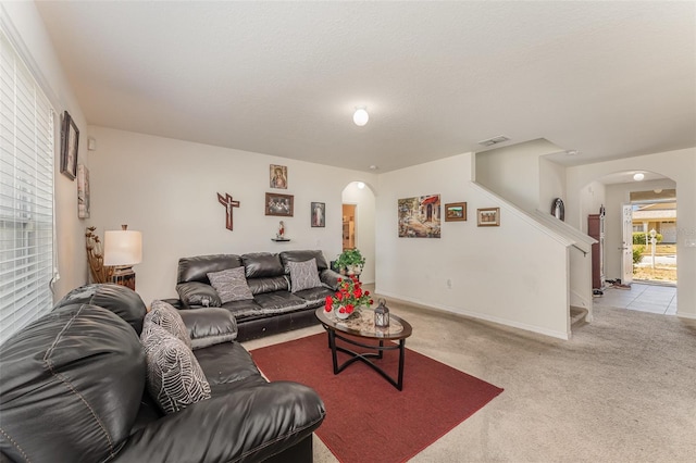 5597 Forest Ridge Dr, Winter Haven, FL 33881 - carpeted living area featuring arched walkways and stairs