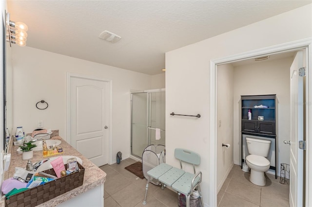 5597 Forest Ridge Dr, Winter Haven, FL 33881 - full bathroom with a stall shower, tile patterned floors, toilet, vanity, and baseboards