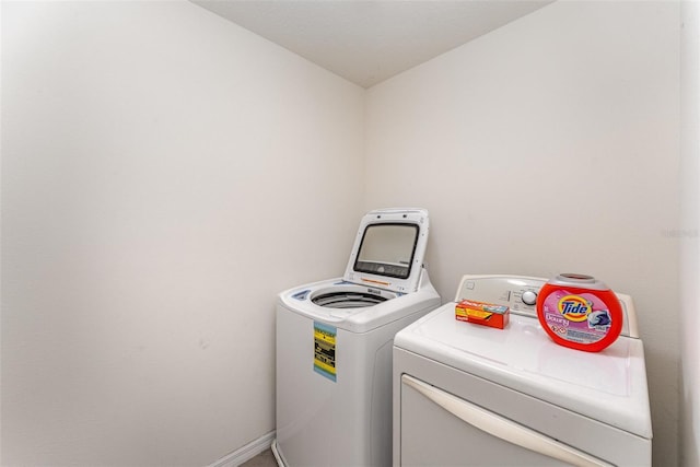 5597 Forest Ridge Dr, Winter Haven, FL 33881 - washroom with separate washer and dryer and baseboards