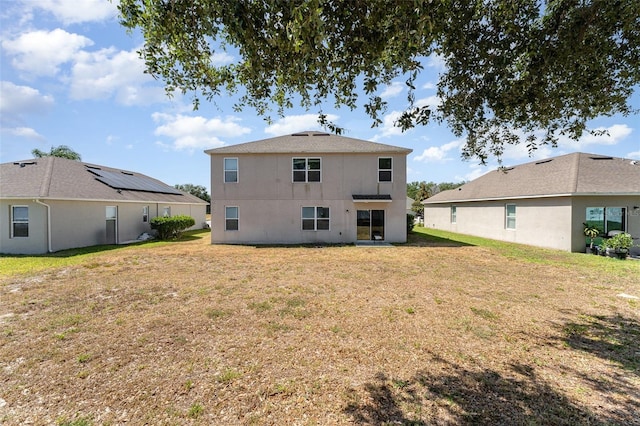 5597 Forest Ridge Dr, Winter Haven, FL 33881 - rear view of property with a lawn