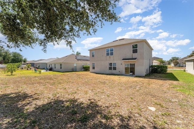 5597 Forest Ridge Dr, Winter Haven, FL 33881 - rear view of property featuring a lawn and stucco siding
