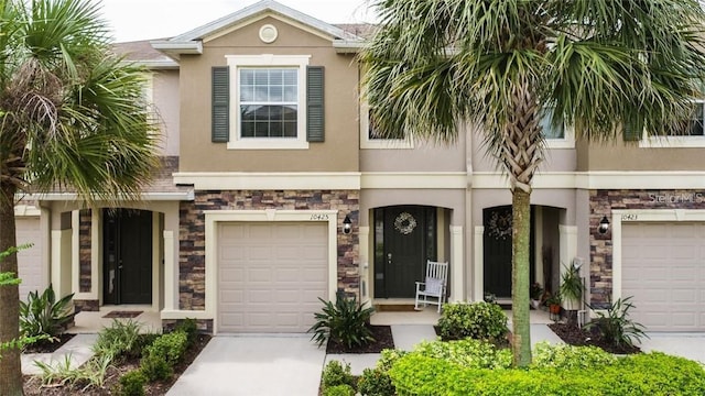 10425 Yellow Spice Ct, Riverview, FL 33578 - view of front of property featuring stone siding, driveway, and stucco siding