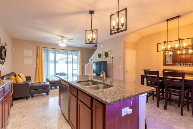 10425 Yellow Spice Ct, Riverview, FL 33578 - kitchen with dark stone countertops, a sink, open floor plan, ceiling fan with notable chandelier, and stainless steel dishwasher