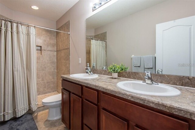 10425 Yellow Spice Ct, Riverview, FL 33578 - full bathroom with a sink, toilet, tiled shower, and double vanity