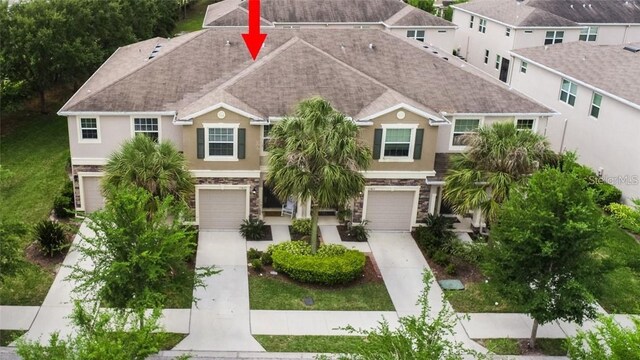 10425 Yellow Spice Ct, Riverview, FL 33578 - multi unit property featuring a garage, stucco siding, stone siding, and concrete driveway