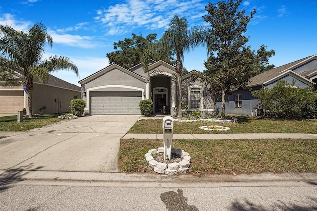 13215 Beechberry Dr, Riverview, FL 33579 - view of front of house featuring stucco siding, an attached garage, a front lawn, and concrete driveway