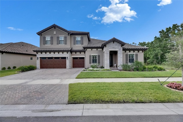 mediterranean / spanish home featuring a garage, stone siding, decorative driveway, stucco siding, and a tile roof