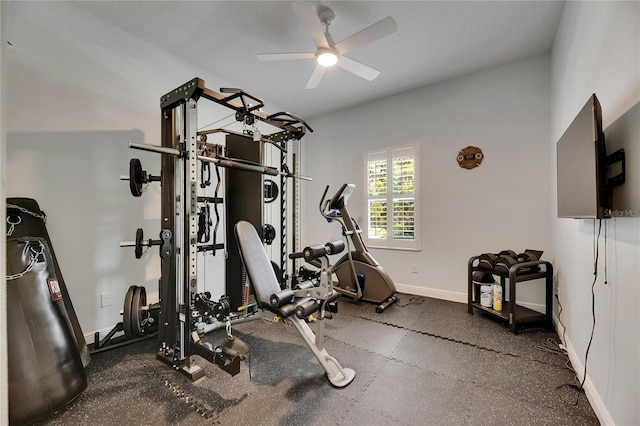 exercise room with baseboards and ceiling fan