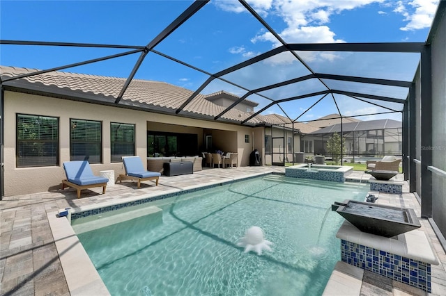 view of pool with a pool with connected hot tub, a lanai, and a patio area