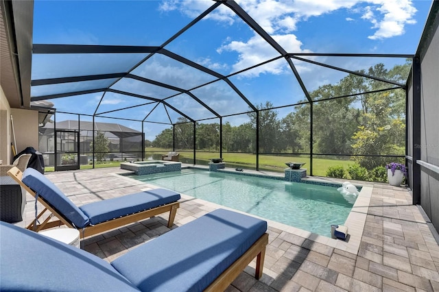 view of swimming pool with a patio, a pool with connected hot tub, and glass enclosure