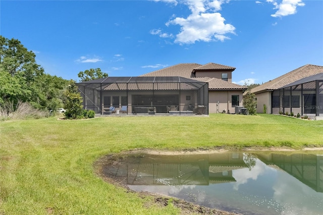 back of house featuring stucco siding, a yard, a tile roof, and cooling unit