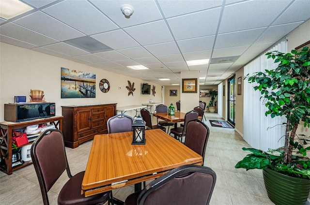 dining area featuring a drop ceiling
