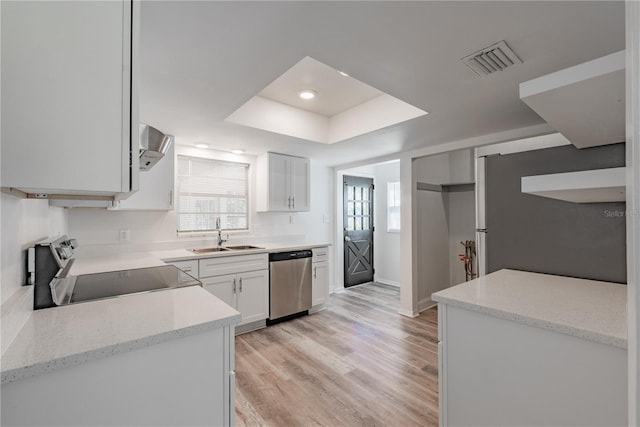 701 W Idlewild Ave, Tampa, FL 33604 - kitchen featuring white cabinets, a sink, visible vents, appliances with stainless steel finishes, and a raised ceiling