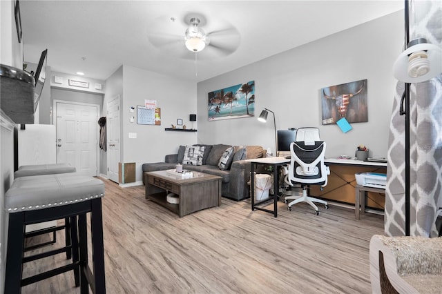 office area with ceiling fan, baseboards, and light wood finished floors