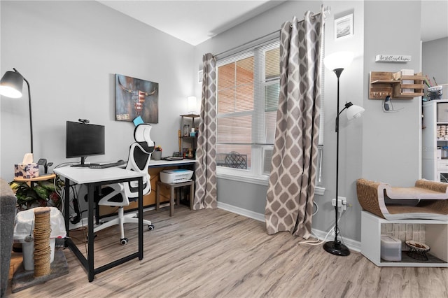 home office featuring baseboards and wood finished floors