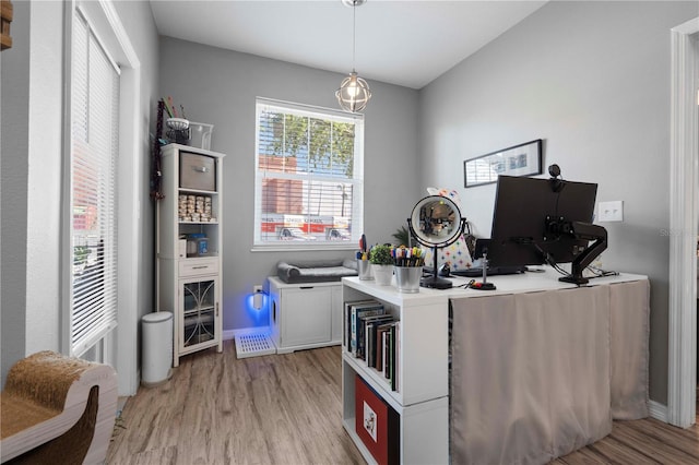 office area featuring baseboards and light wood-style flooring