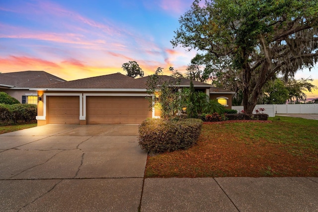 2539 Centennial Falcon Dr, Valrico, FL 33596 - ranch-style home with concrete driveway, a garage, and stucco siding