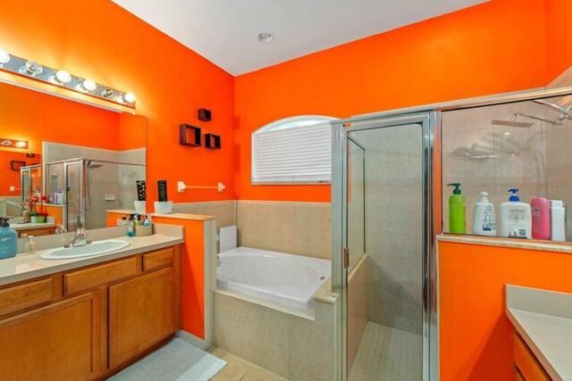 2539 Centennial Falcon Dr, Valrico, FL 33596 - bathroom featuring vanity, a garden tub, a shower stall, and tile patterned flooring