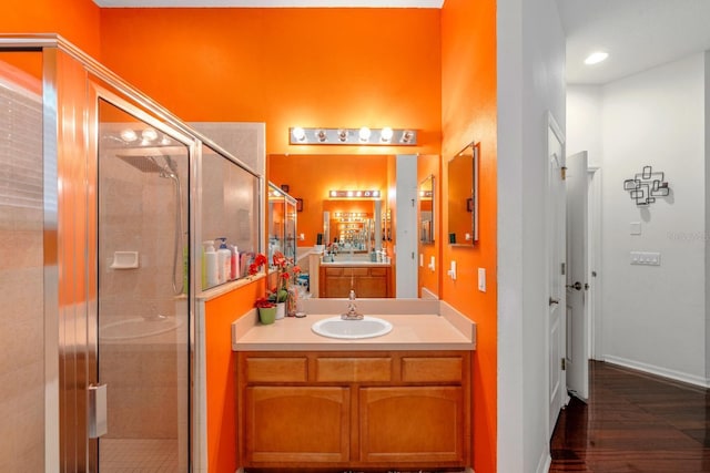 2539 Centennial Falcon Dr, Valrico, FL 33596 - bathroom featuring a stall shower, vanity, and wood finished floors