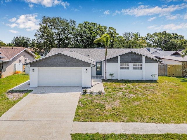 12641 98th St, Largo, FL 33773 - view of front of house featuring a garage, fence, driveway, and a front lawn