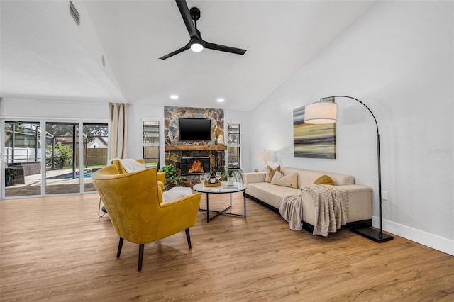 12641 98th St, Largo, FL 33773 - living area with visible vents, baseboards, a stone fireplace, ceiling fan, and wood finished floors